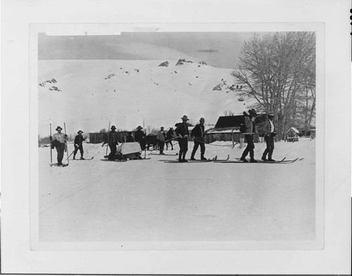 Rescue team carries Mrs. Mason from the destroyed powerhouse at Jordan Hydro Plant past the Mattley Ranch to Bodie