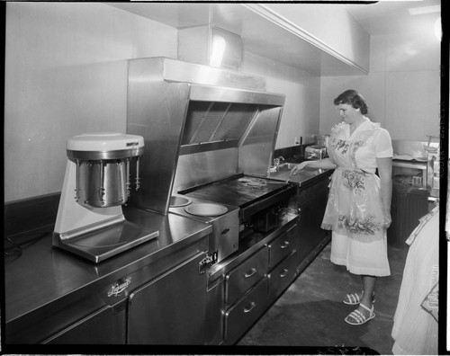 Chef cooking on electric grill in commercial grade kitchen