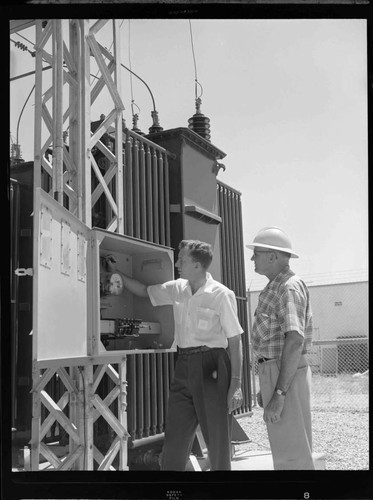 Men inspecting meter box at North East City Substation