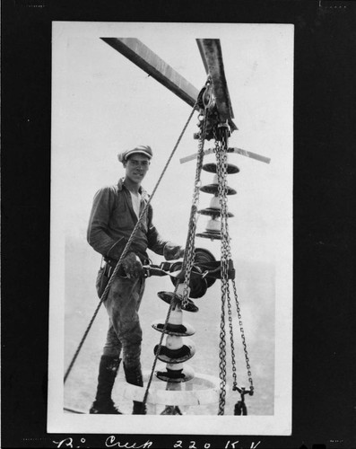 Lineman hanging insulators on Big Creek transmission line