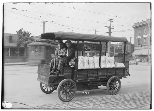 Two grocers in the Smith's Grocery electric truck