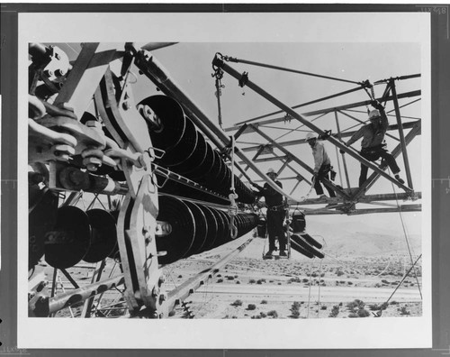 Edison Company linemen use a "shepherd's hook" tool to install a 500kV insulator on a Pacific Intertie tower