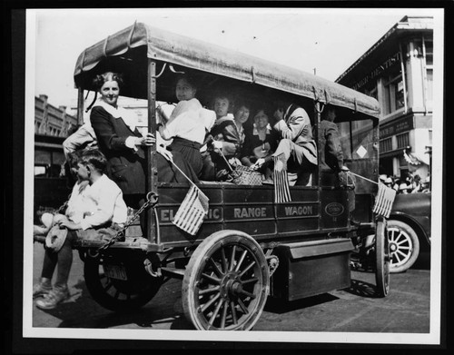 Electric Range Delivery Wagon with ladies waving American flags