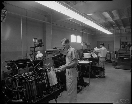 Men working in the pressroom of the Ledger Gazette