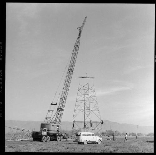 Transmission tower construction using a crane