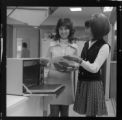 Lady demonstrating a microwave oven