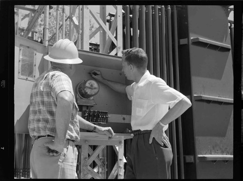 Men inspecting meter box at North East City Substation