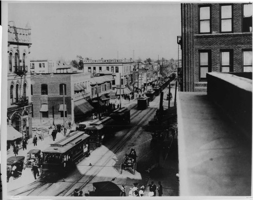 View of rush hour shows Los Angeles Railway trolley cars lined up on East Seventh Street