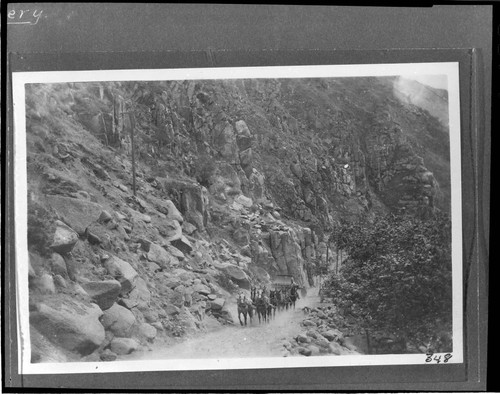 A section of penstock for Kern River #1 Hydro Plant being hauled up the trail in Kern River Canyon by a team of horses