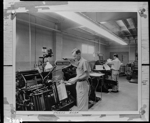 Men working in the pressroom of the Ledger Gazette