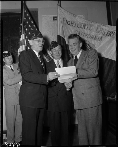 Men looking at document at meeting of American Legion