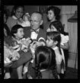 Little girls receiving Christmas dolls