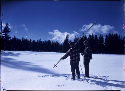 Big Creek Snow Survey: two men with measuring tube (snow pole) lifted