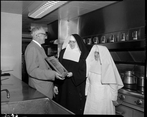 Saint Francis Hospital nuns receiving Merit Award from Institutions Magazine in hospital kitchen