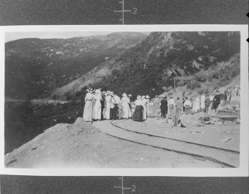 A group of people standing along the side of a cliff watching the opening of Kaweah #3 Hydro Plant