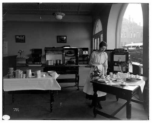 Miss Ebert conducting a cooking demonstration [with electric appliances] at Edison Redlands Service Center