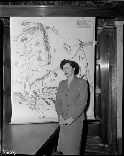 Woman standing in front of display map of Edison system at the GO