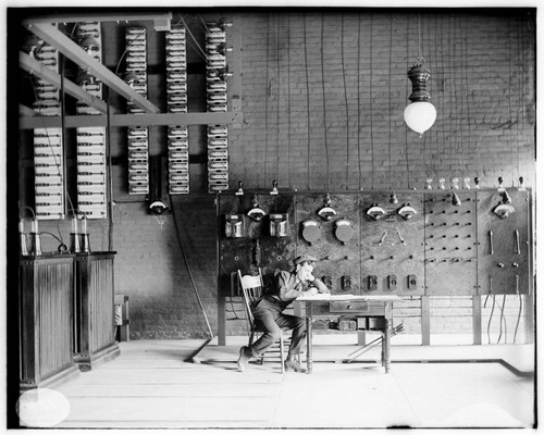 An operator sitting at a desk in front of the switchboard at the Pomona Substation