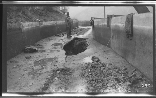 A man standing by the first break in the ditch at Kaweah #3 Hydro Plant