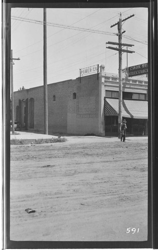 The Tulare Local Office building. showing a sign reading: "COOK WITH ELECTRICITY". an ad reading: "WALK-