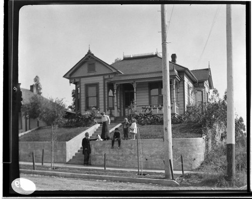 A family on the front lawn of a house