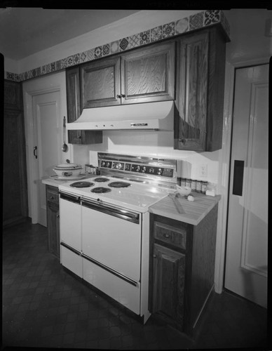 Electric range built into an older remodeled kitchen