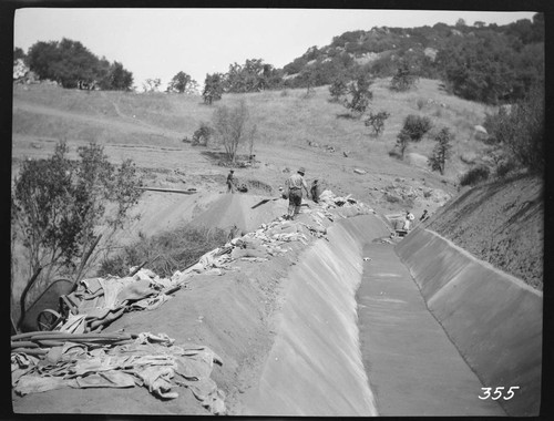 A construction crew plastering the ditch at the Tule Plant