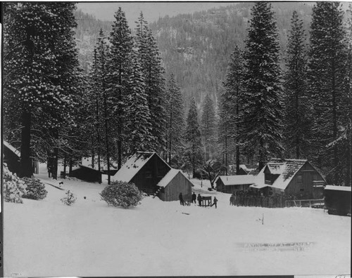 Men are lined up in wet January snow at Camp #2 to pick up their gold coins from the paymaster