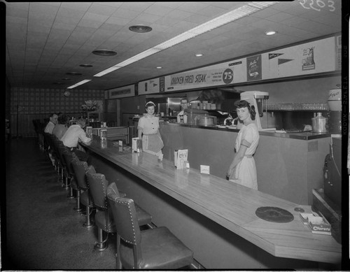 Lunch counter with waitresses behind counter