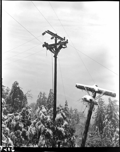 Linemen working at top of pole in snow