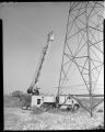 Bucket truck cleaning insulators on transmission line with high pressure nozzle