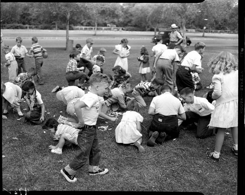 Kids scrambling on grass for goodies