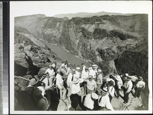 A group of newspaper men, Reclamation Officials, and Representatives of Six Companies, Incorporated, at the Government Observation Platform overlooking the Hoover Dam site