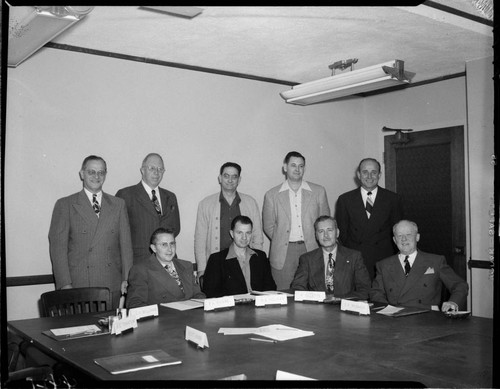 Posed photograph of 9 officers in Edison board room