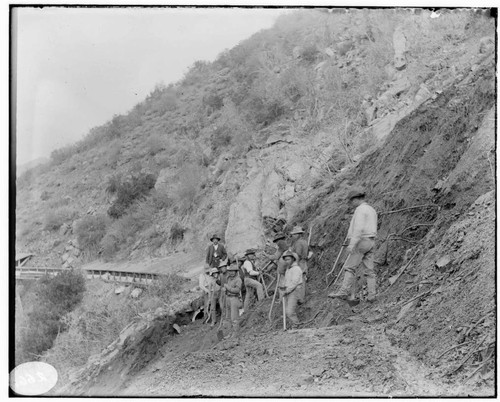 A group of men clearing a landslide on the Mill Creek #2 Hydro Plant line