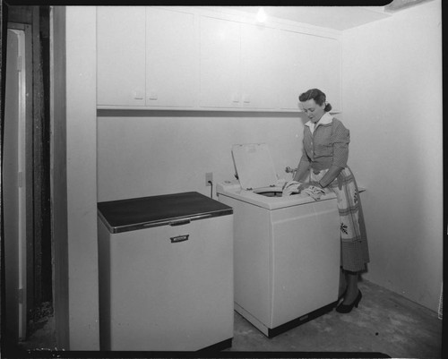 Woman loading washing machine