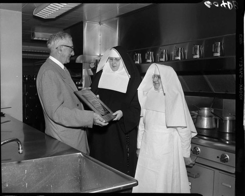 Saint Francis Hospital nuns receiving Merit Award from Institutions Magazine in hospital kitchen