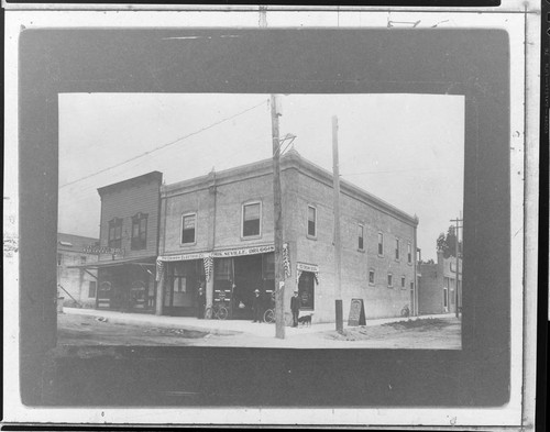 A man and a dog standing outside the Edison Electric Company local office in Monrovia around 1905