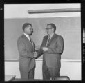 Men reviewing certificates of completion for Edison electronics training