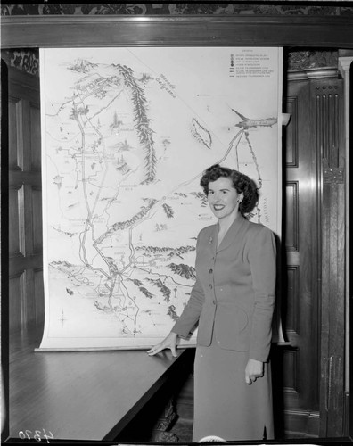 Woman standing in front of display map of Edison system at the GO