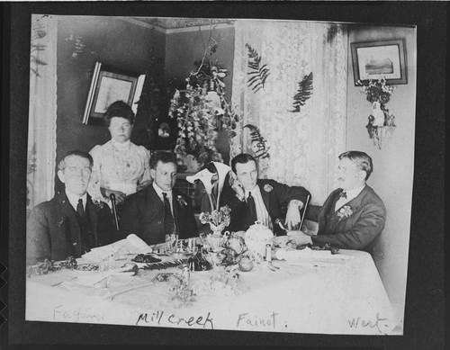 A dinner at the superintendent's house at Mill Creek #1 Hydro Plant. Men seated (l-