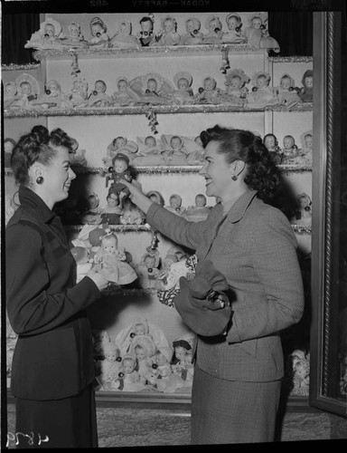 Two ladies with Christmas doll display