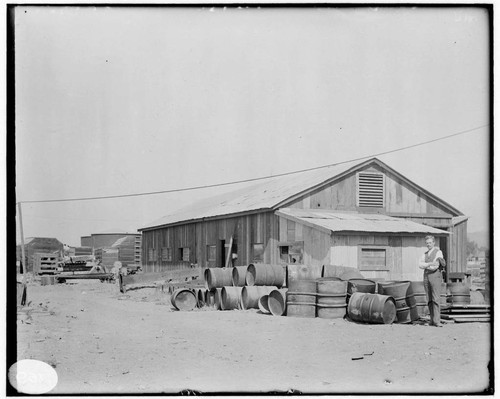 A man standing in front of the Machine Shop at Los Angeles #3 Steam Plant