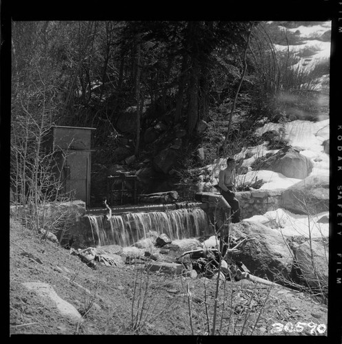 View along Tombstone Creek diversion dam. Gate is closed and all water is spilling over crest (note