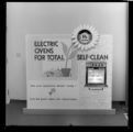 Signs promoting self cleaning electric ovens and electric clothes dryers