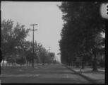 Linemen on a divided road removing wooden transmission poles on road division