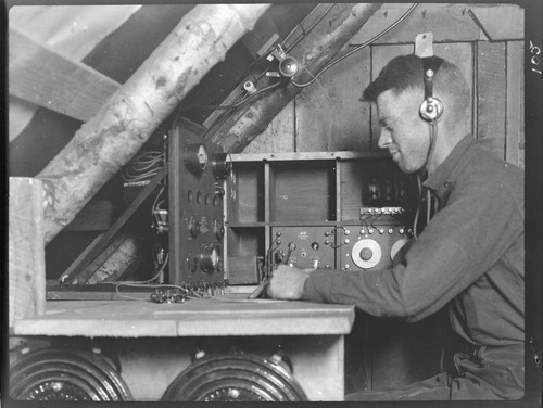 Operator in radio shack receiving and recording a message