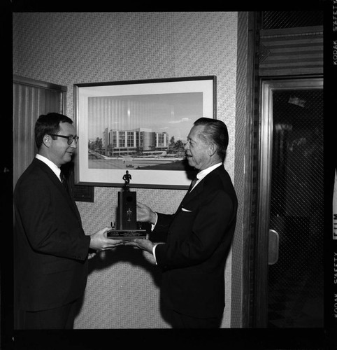 Building architects receiving trophys and awards