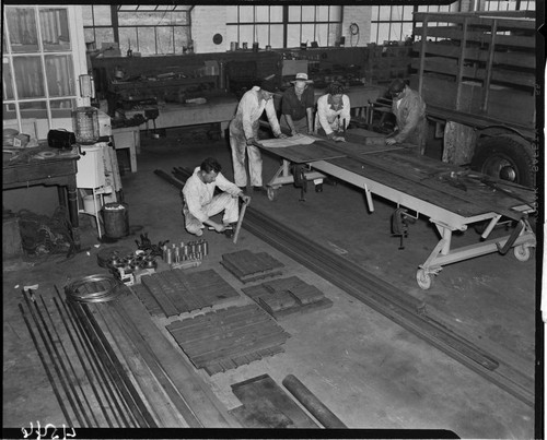 Men reviewing plans on work bench