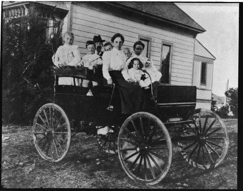 Mrs. Ensign and George W. Williams in the car built by George Williams and Orville H. Ensign